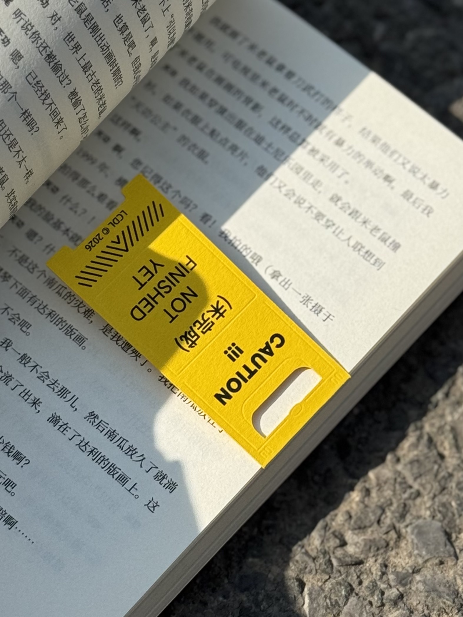 CAUTION bookmark in a book